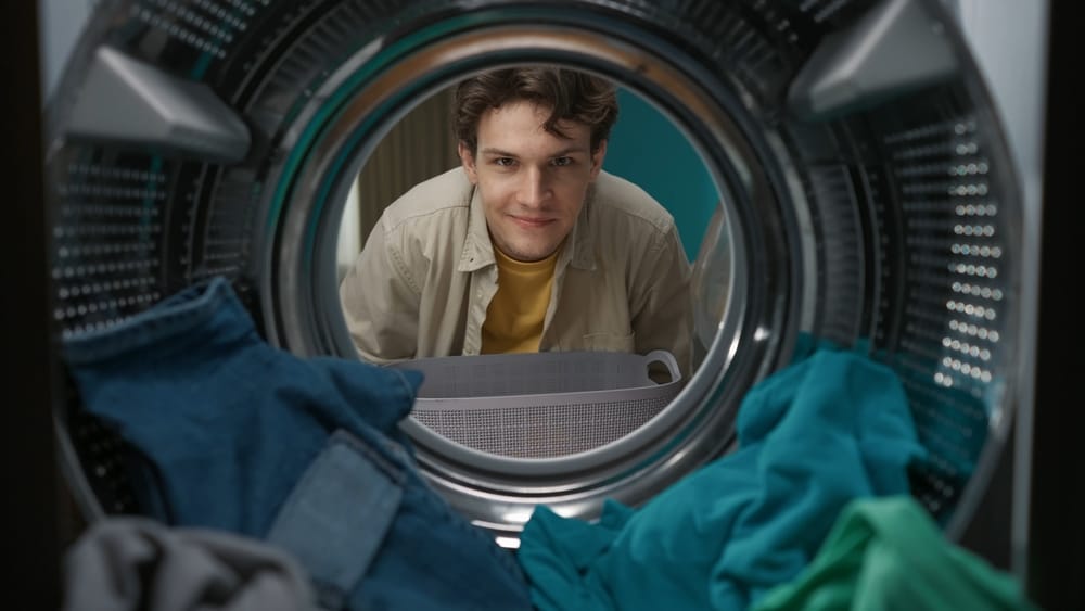 view,from,inside,the,washing,machine,,adult,man,looking,at